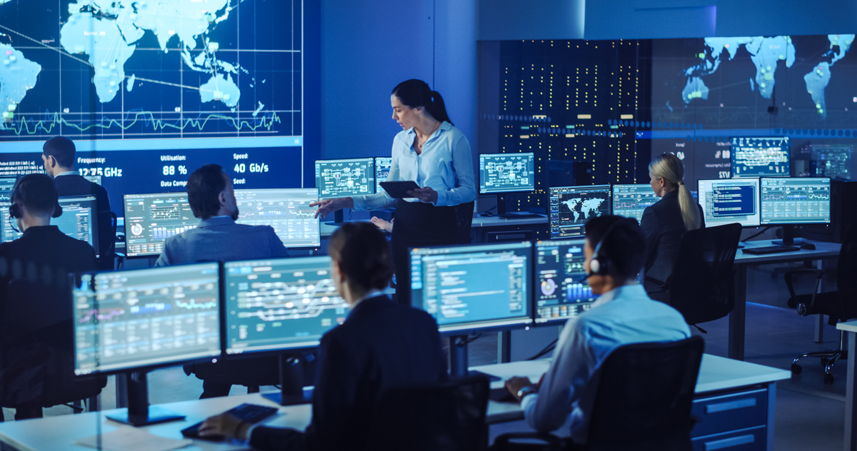 Cybersecurity professionals on computers in office